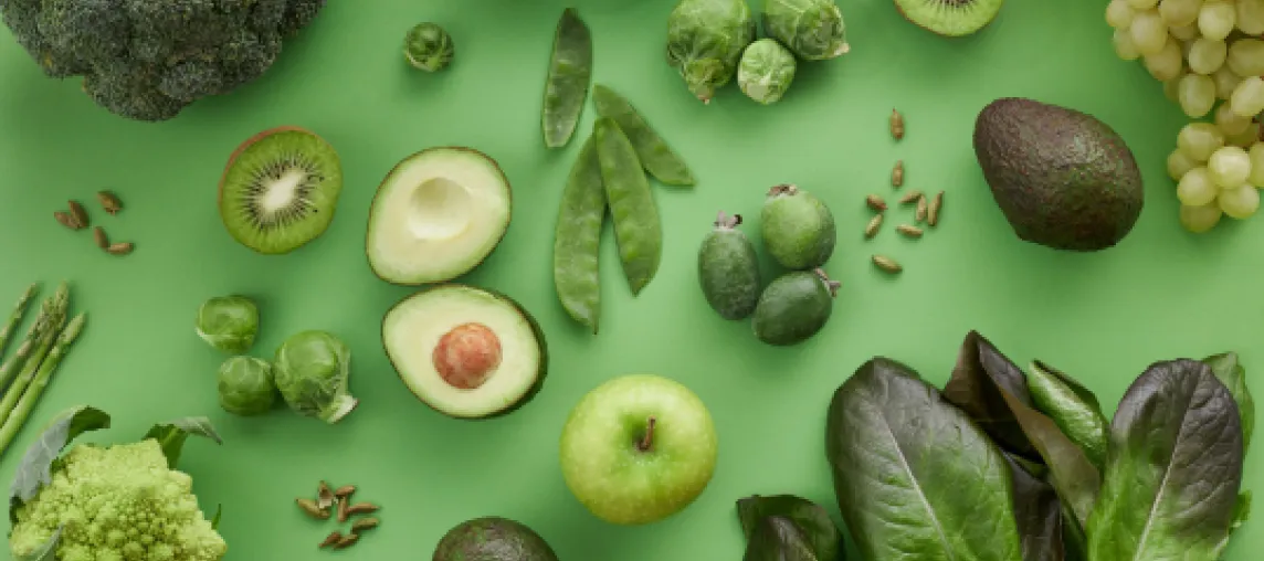 foto con sfondo verde e composizione di frutta e verdura